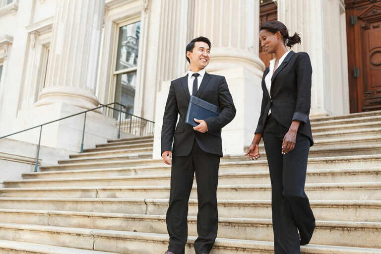two business people walking down steps